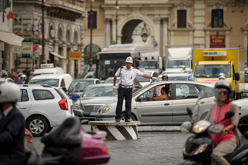 Rome, Italy - September 18, 2014: A Policeman regulates traffic at a intersection in Rome.
