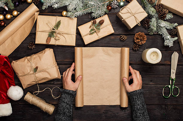 istock Man's hands holding a blank christmas paper 629572516
