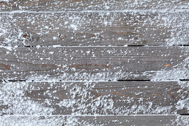 istock Winter background with natural snow on wooden board 629572626
