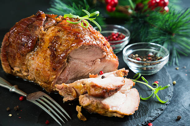 istock Christmas ham with spices and herbs 629574180