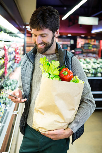 istock Couple holding grocery bag 629579200