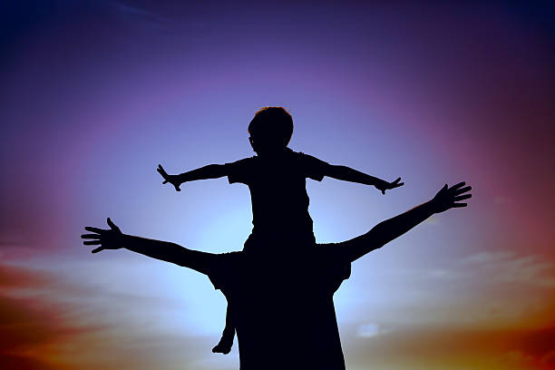 istock father and son play on sunset sky 629579590