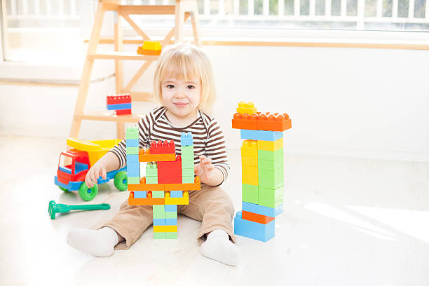 istock Little boy playing with colorful plastic blocks 629583766