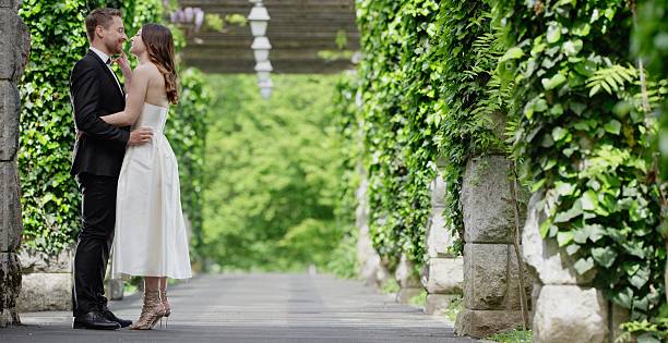 istock Bride and groom together in park 629585154
