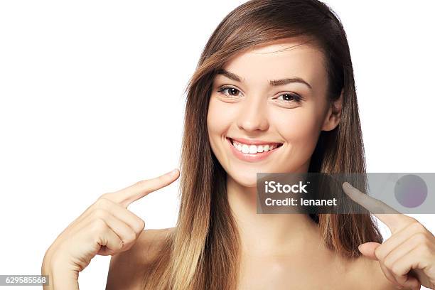 Pointing To Teeth Stock Photo - Download Image Now - Smiling, White Color, White People