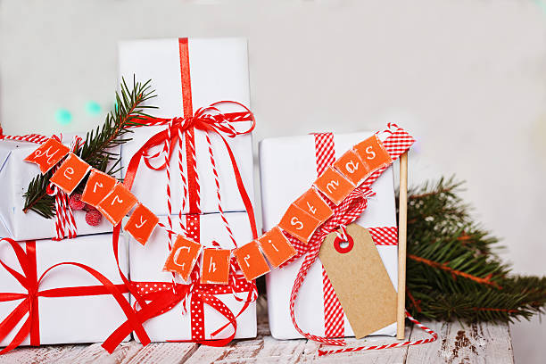 istock Group Christmas white gift boxes with red ribbons and garland 629585608