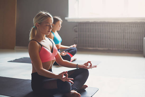 istock Young women in yoga class, relax meditation pose 629586020