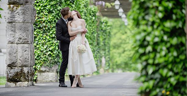 istock Bride and groom kissing 629586130