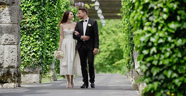 istock Bride and groom walking together 629586174
