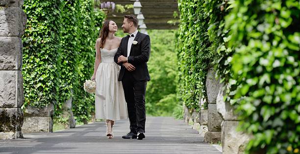 istock Bride and groom walking together 629586246