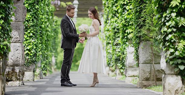 istock Bride and groom together in park 629586408