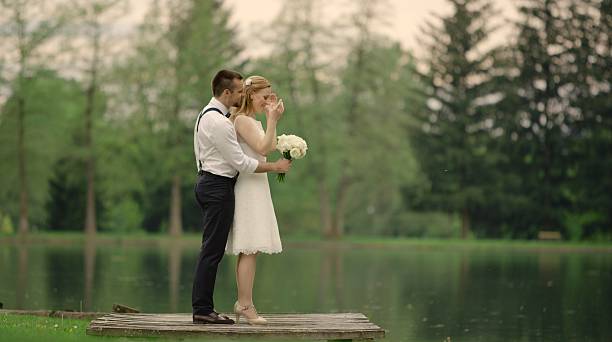 istock Bride and groom near lake 629586962