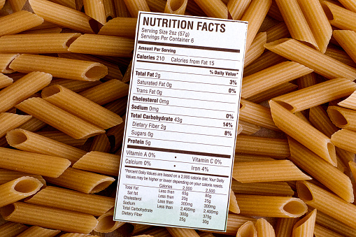 Nutrition facts of Brown Rice Pasta on pasta background. Gluten free concept.