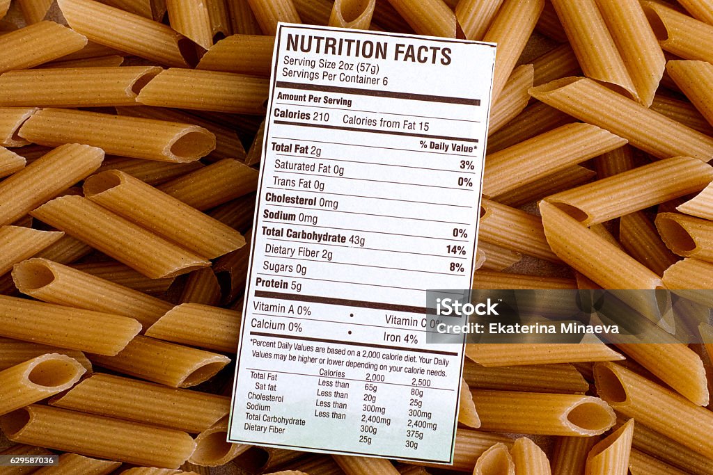 Nutrition facts of Brown Rice Pasta Nutrition facts of Brown Rice Pasta on pasta background. Gluten free concept. Nutrition Label Stock Photo