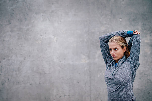 istock Female runner stretching arms after a running session 629587124