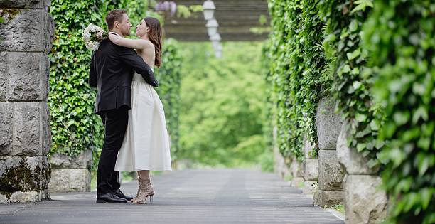 istock Bride and groom together in park 629588400
