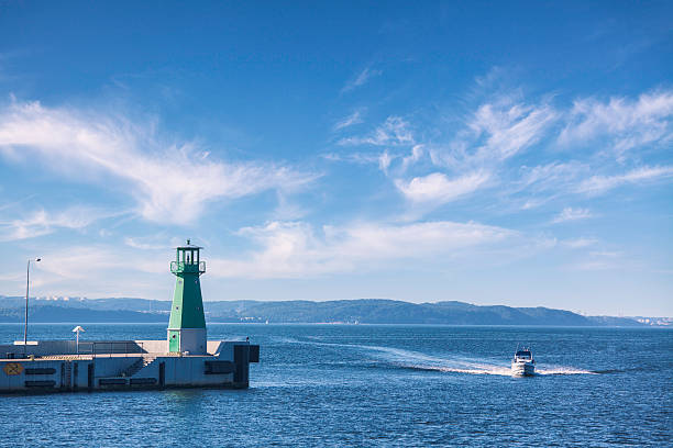 A lighthouse at the end of the pier (Falochron Zachodni) in Gdansk on the coast of Poland, with a view towards Gdansk Bay and the Baltic Sea.