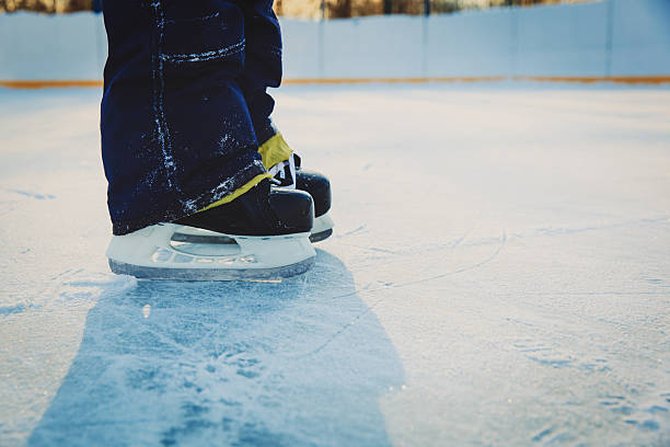istock little boy feet learning to skate on ice in winter 629590444