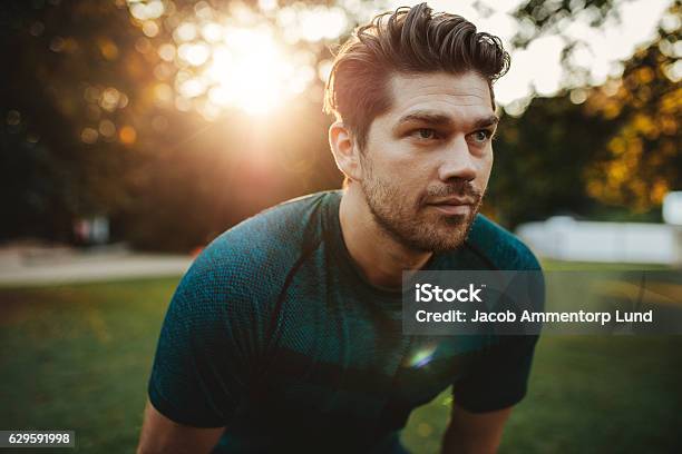 Healthy Young Man Standing Outdoors In Park Stock Photo - Download Image Now - Men, Running, Determination