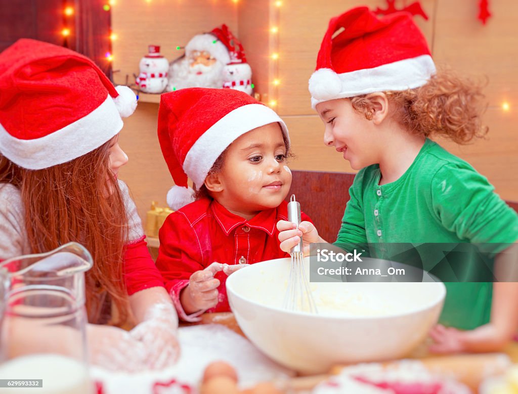 Three Kids Making Christmas Cookies Stock Photo - Download Image Now