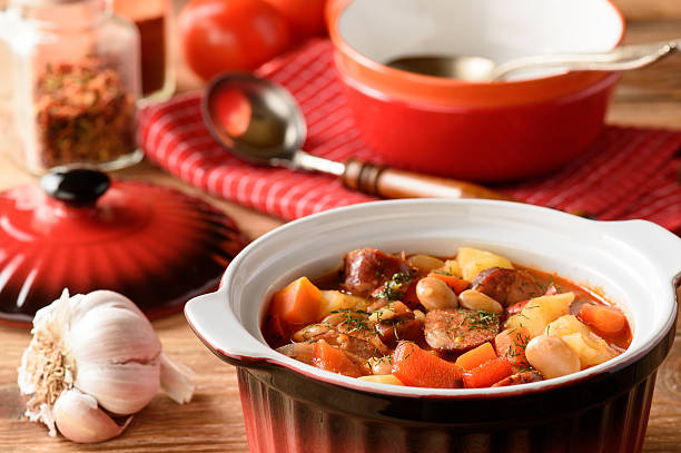 istock Hot soup with vegetables, smoked sausages and bean. 629593434