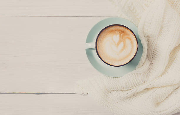istock Winter cappuccino coffee cup on white wood background 629593858