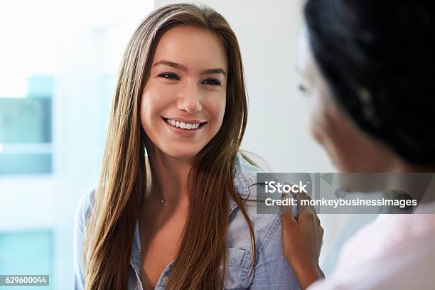 Female Doctor Meeting With Teenage Patient In Exam Room Stock Photo - Download Image Now