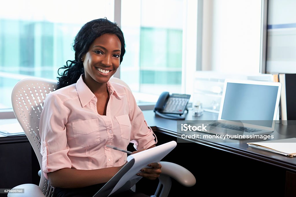 Portrait Of Female Doctor Working In Office African Ethnicity Stock Photo