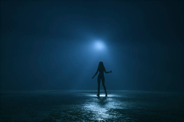 istock Woman hitchhiking ufo at night 629601362