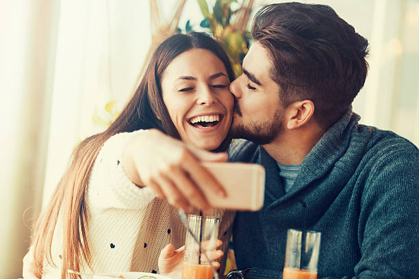 istock Happy beautiful couple using smart phone in cafe 629601744