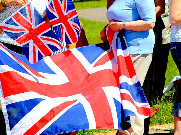 Union flags. Chatsworth, Derbyshire, UK. July 10, 2014. Spectators with union flags waiting for the visit of the Queen at Chatsworth in Derbyshire. prince phillip stock pictures, royalty-free photos & images