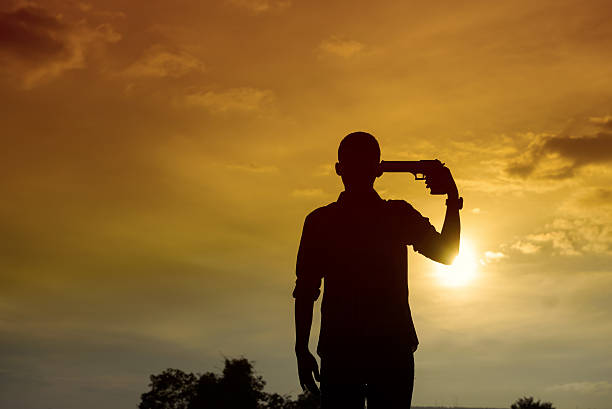 istock Shadow of man with pistol gun turned on his head 629603506