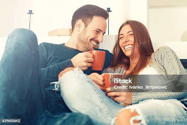 Happy Young Couple At Home Stock Photo - Download Image Now - Couple - Relationship, Coffee - Drink, Domestic Life