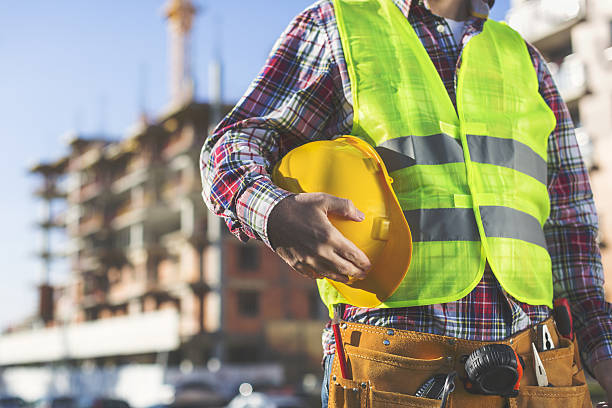 Construction Worker  holding helmet stock photo