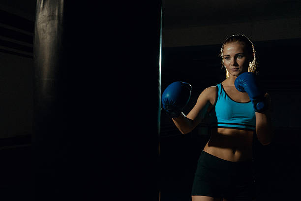 istock boxing woman in black punching bag 629605968