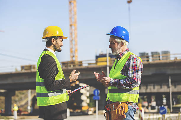 Two Construction Works 44,100+ Two Construction Workers Stock Photos, Pictures & Royalty-Free ...