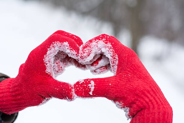 istock Making heart shape on winter day in red gloves 629611134
