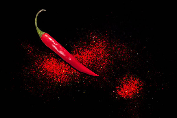 istock Fresh hot peppers. Chili spice powder on black background. 629612012