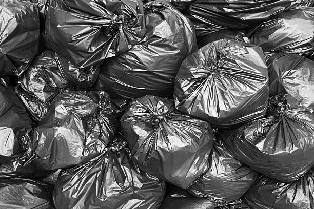 a pile of black garbage bags. - bag garbage bag plastic black imagens e fotografias de stock