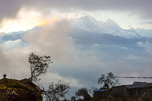 istock Sunset Mountain View with Clouds around high Peaks warm 629613738