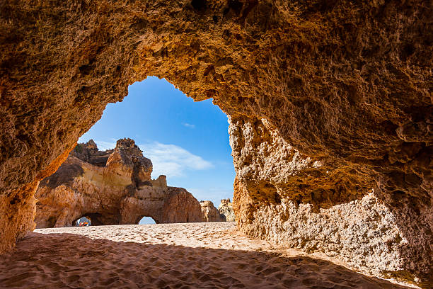 Early morning at the beach Limestone arches - Praia Dos Tres Irmaos near Portimao alvor stock pictures, royalty-free photos & images