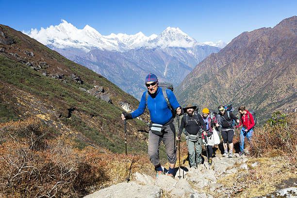 group of mountain climbers walking up on mountain trail - journey footpath exercising effort imagens e fotografias de stock