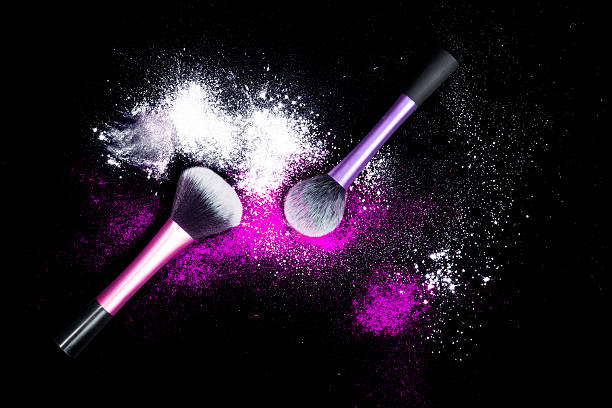 istock Make-up brushes with colorful powder on black background. 629615922