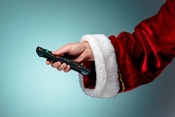 Santa Claus holding tv remote control