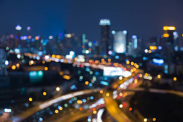 istock Twilight blurred light highway interchanged with city downtown background 629617356