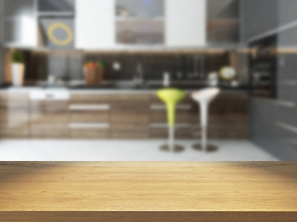 istock empty wooden desk with blurred kitchen 629625050