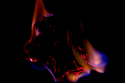 Beautiful concept flames. Fire on burns paper with black background. Soft Focus