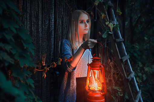 Young girl with lantern in fairy tale