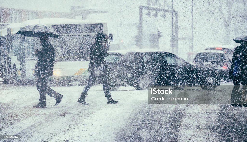 Pedestrians and traffic on a winter day Pedestrians and traffic on a winter day. Snowing Stock Photo