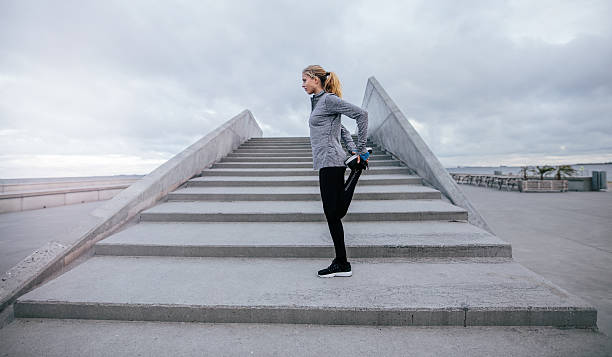 istock Young female stretching her leg outdoors 629638802
